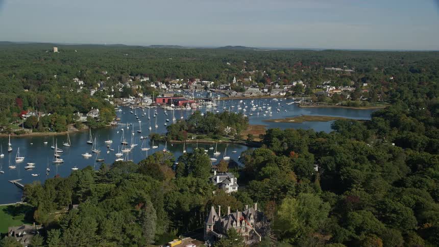 A region with a river full of boats and surrounded by forests
