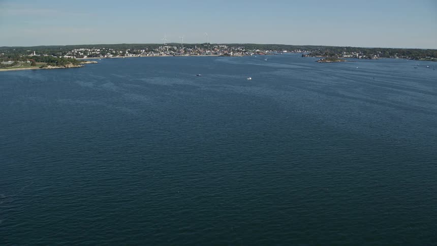 Aerial view of the sea with an urban city on the horizon