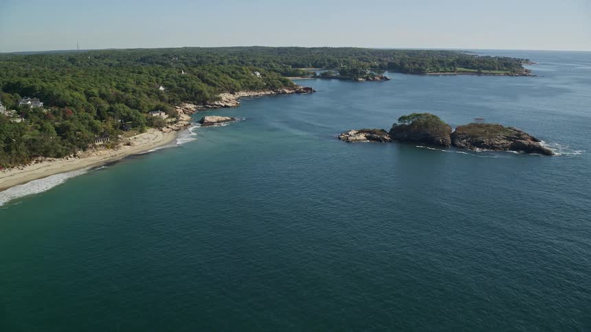 Aerial panorama of a beach with some houses on the coastline