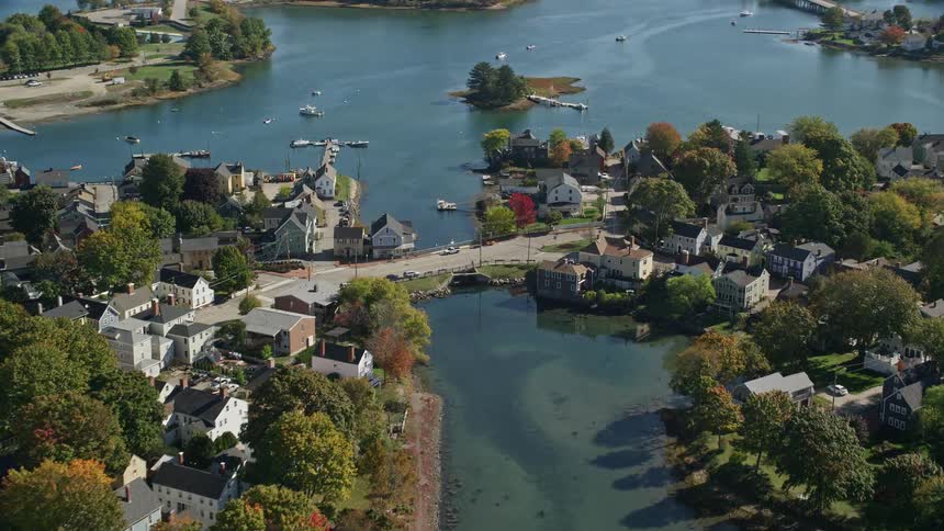A region with several houses on land surrounded by a river