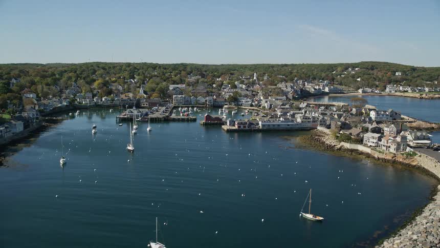 Aerial panorama of an urban city by the seaside with docks and yachts