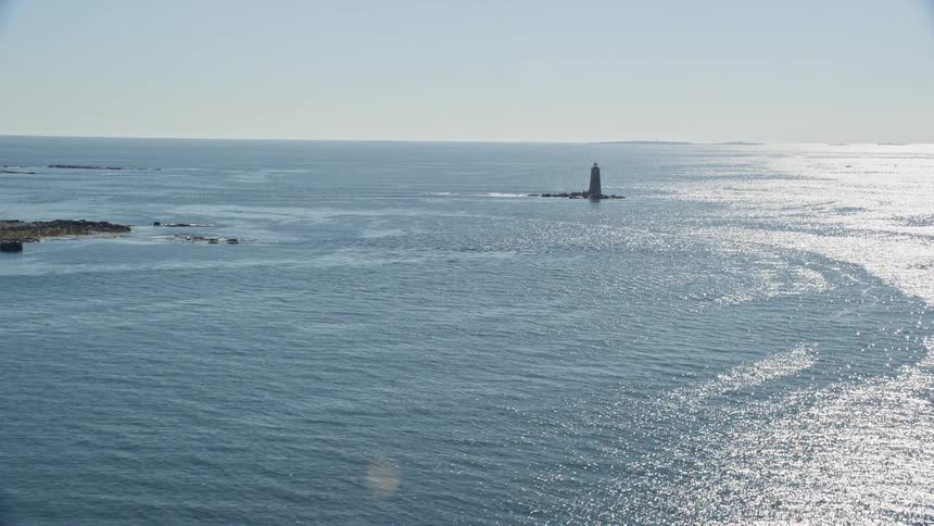 Aerial view of a lighthouse on an island in the ocean