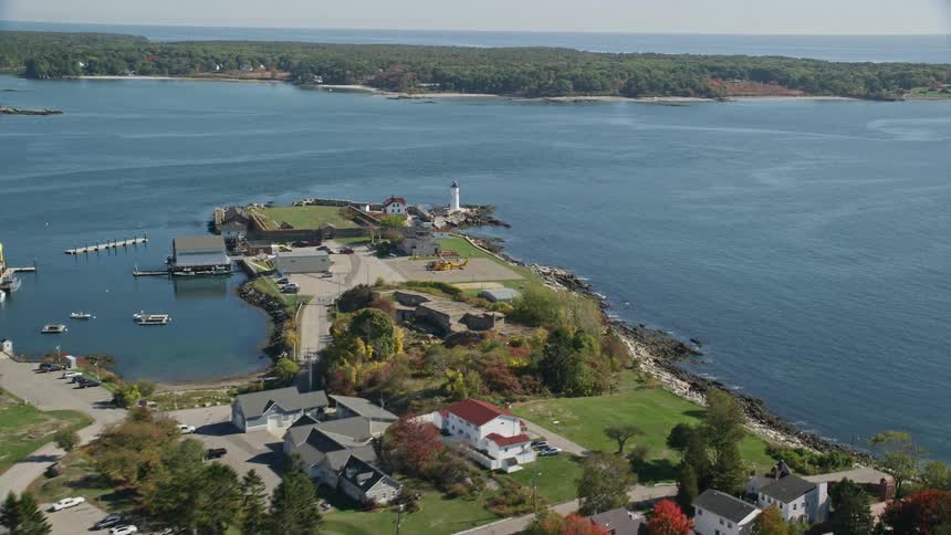 Aerial view coastal homes and lighthouse on fall day