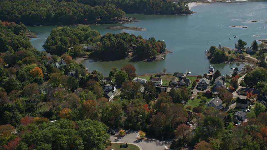 A rural region in front of a bay with some houses