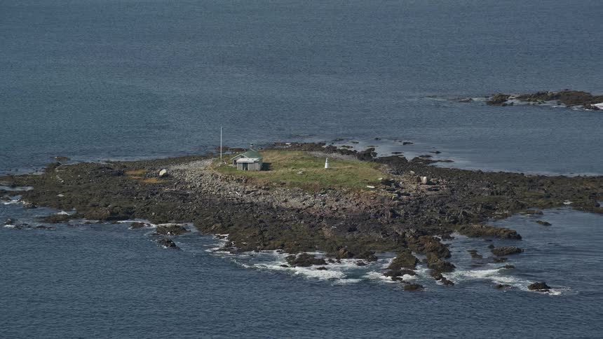 A small cabin on a desert island in the middle of the ocean