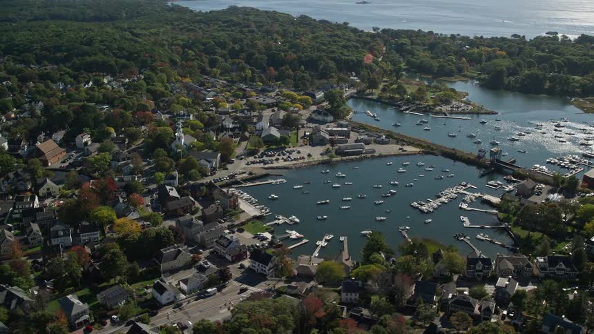 Aerial view of boats on a marina in a small coastal town