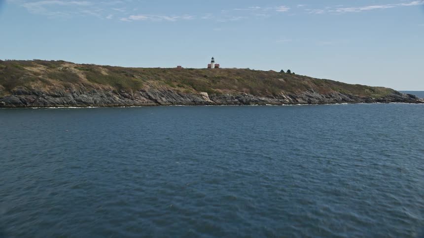Skyline lighthouse on a coastal mountain during the day