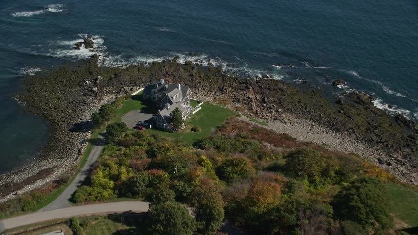 An aerial panorama of a city with a mansion by the sea on a peninsula