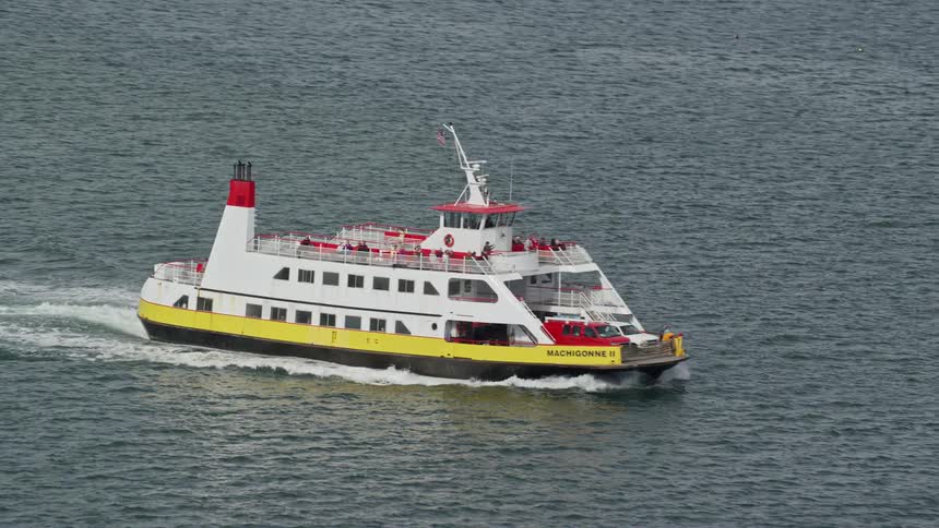 Sightseeing boat with people in the open sea in motion