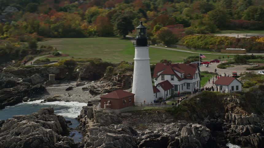 People visiting a lighthouse in a small coastal town