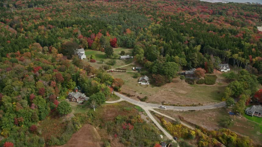 An aerial view of a rural community closer to the woods