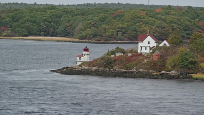 A light house is on the shore