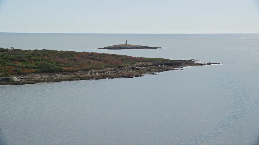 A single boat is near the islands