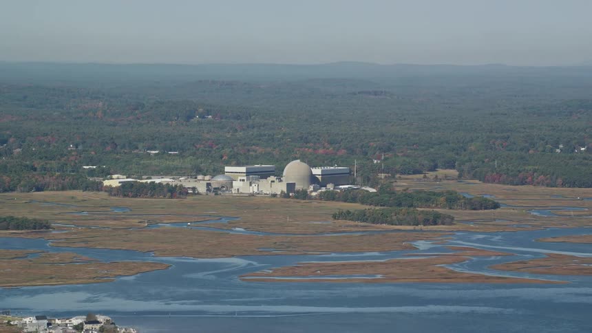 A factory is in the distance from the town
