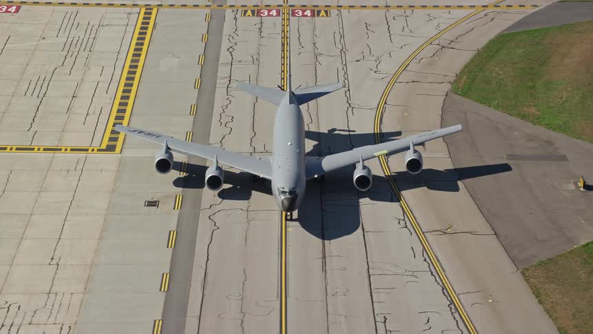 A large private plane on an airstrip is preparing to take off