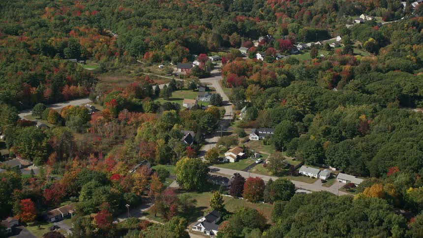 An aerial panorama of an urban city surrounded by green areas