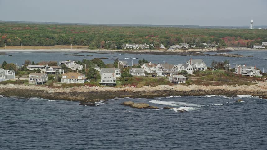 Residential houses on a small land surrounded by water at midday