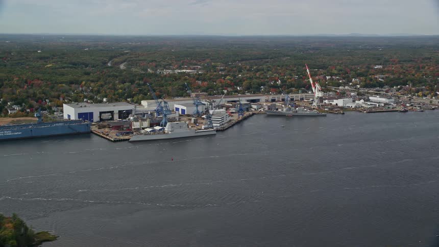 Ships on a pier next to a coastal town