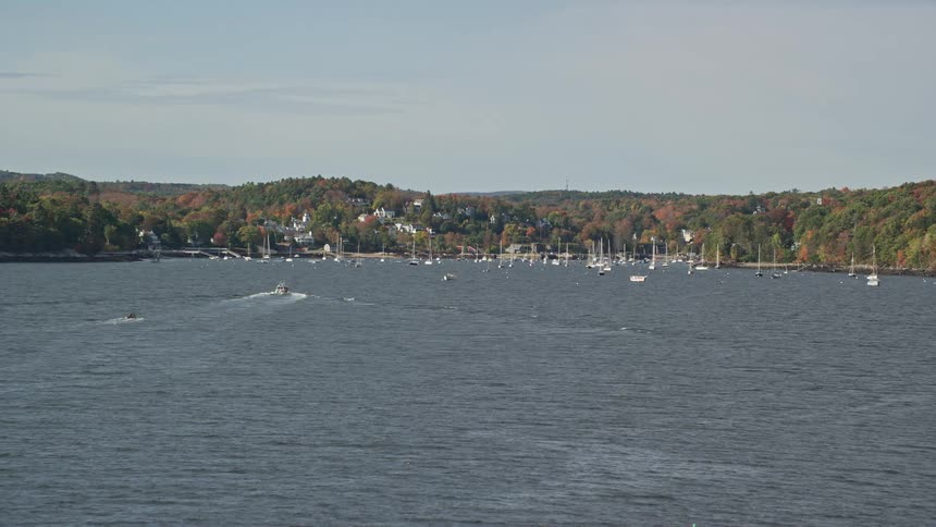 Aerial of beach coast with marina in a small town