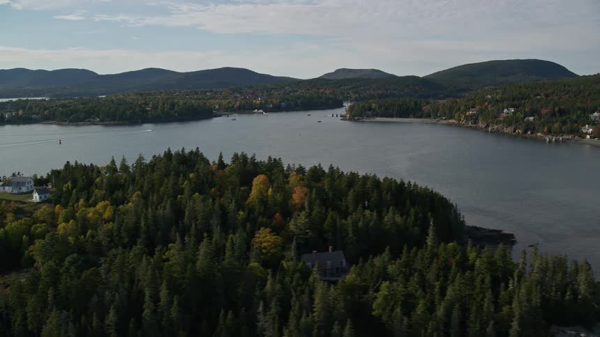 A small house on an island surrounded by a river and with many trees