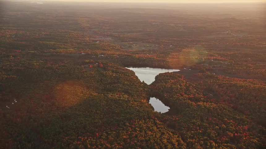 Aerial view of a small lake in the countryside at evening