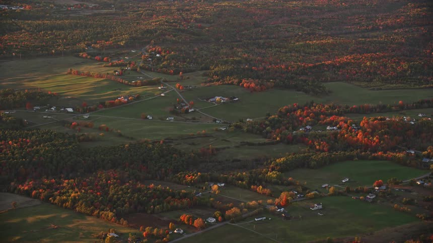 The houses are spread out far on the horizon