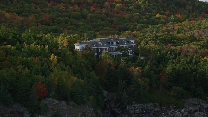 A mansion is on the cliff by the shore