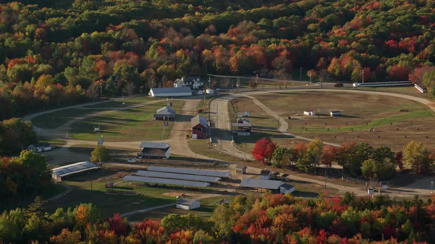 Arial of a small farm in a rural town with a main road