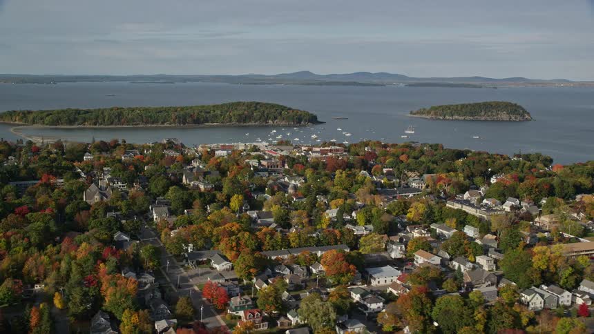 An aerial shot of a coastal suburban neighborhood in the fall