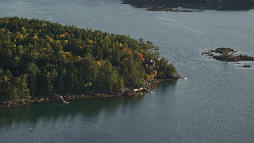 Aerial view of a small forested island surrounded by water