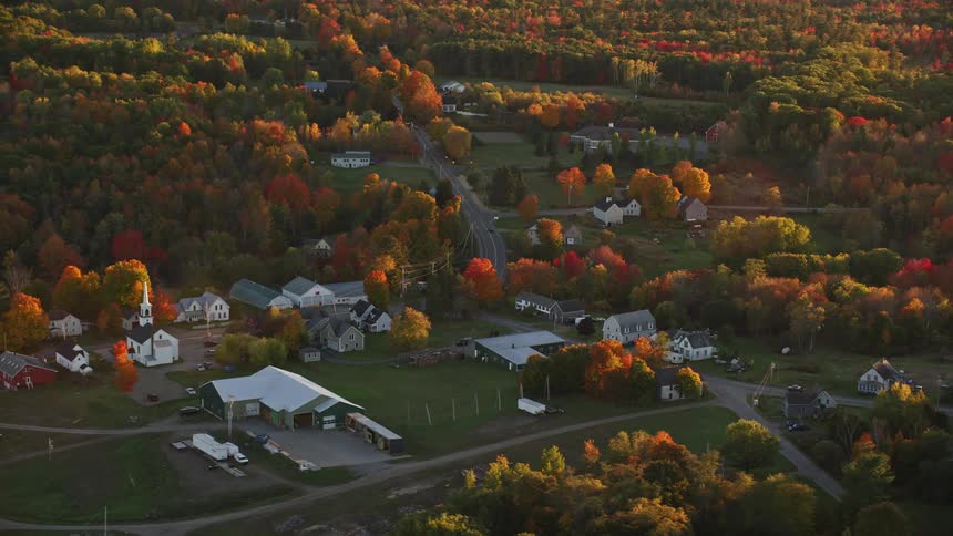 An aerial shot of a small rural town in autumn