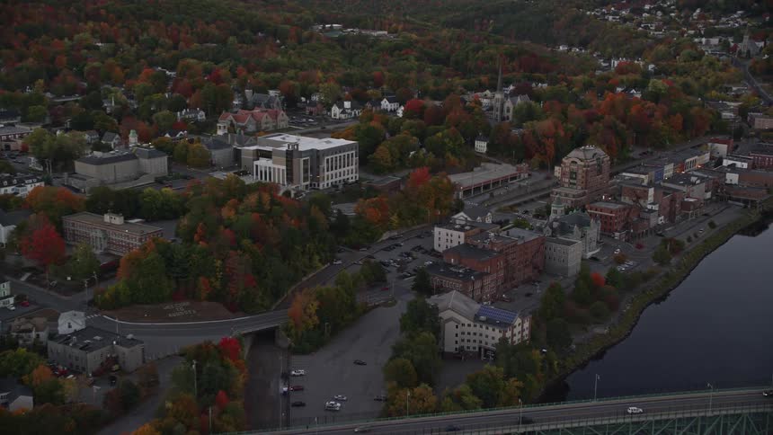 Aerial view of a suspension bridge over a river next to a small town