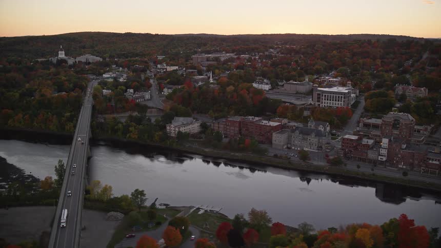 Aerial view of waterfront houses bridges over a river at sunset