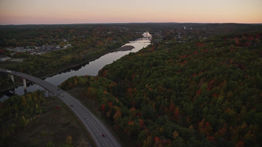 Aerial view of a bridge over a river next to a small town