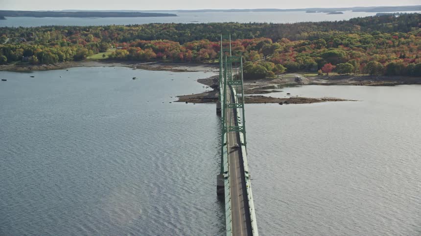Aerial view of a massive bridge under the sea with vehicles passing