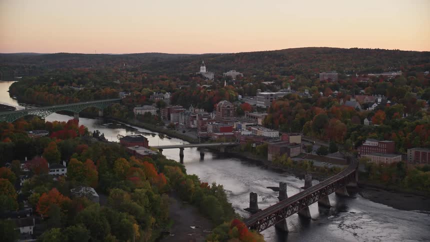 Aerial view of a bridges over a river next to a small town