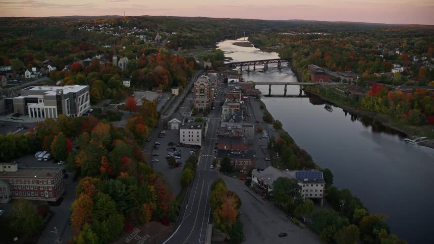 Aerial view of bridges over a river next to a rural town