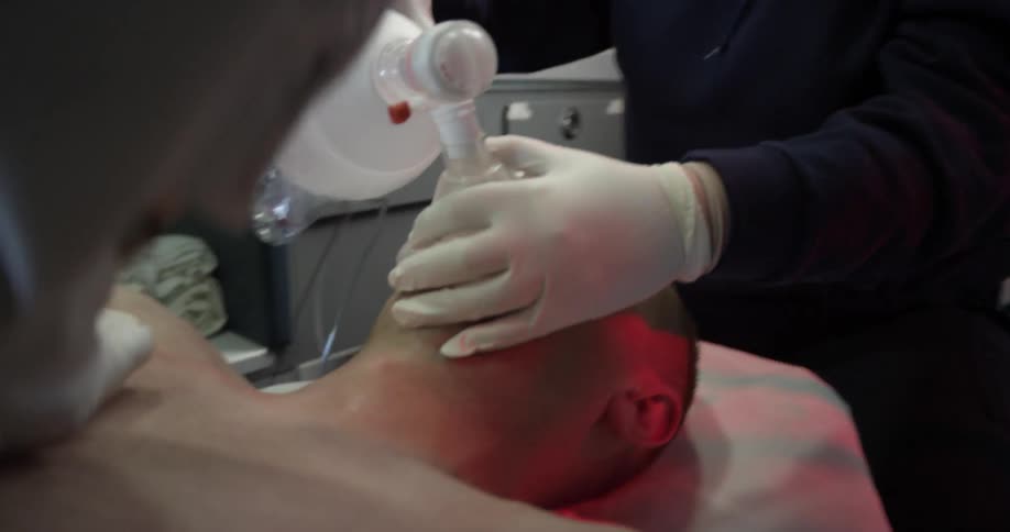 Emt workers trying to revive a patient inside an ambulance