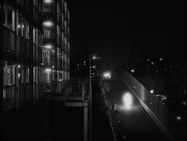A luminous shape walking through the city at night
