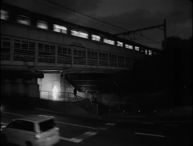 A person made of light walks on the city under a bridge