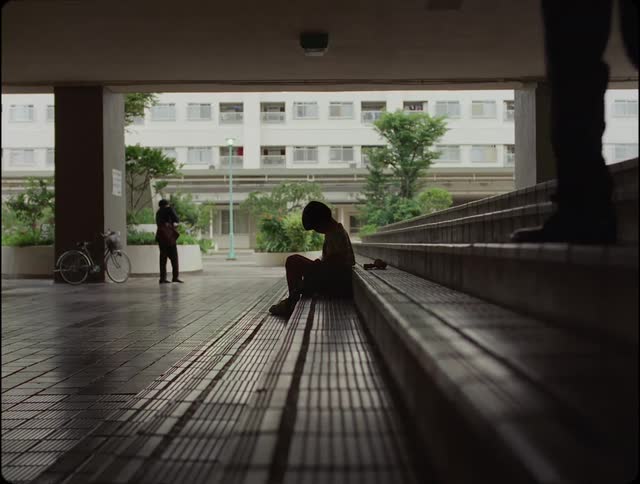 A sad child sitting on the stairs