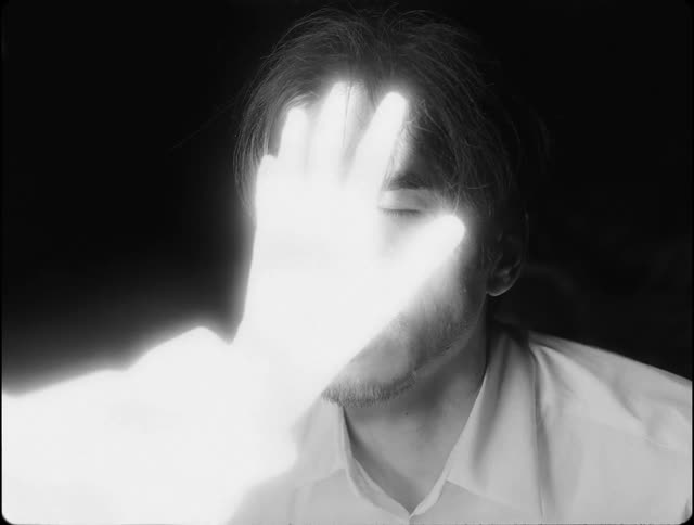 Brilliant hand touching a mans face