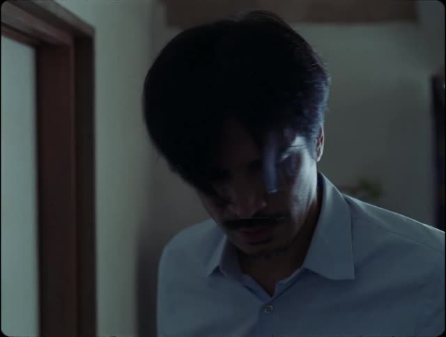 Confused man closes a door and walks away revealing a newton pendulum