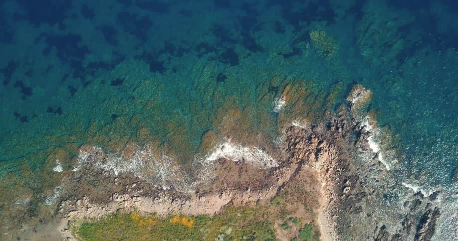 Aerial view of waves washing over the coast