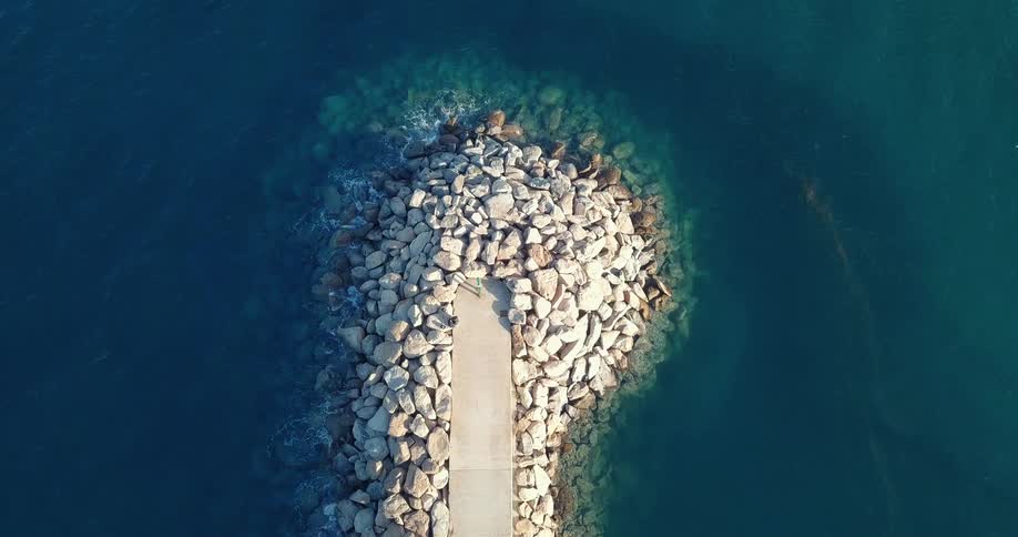 Narrow pier extending out into the ocean