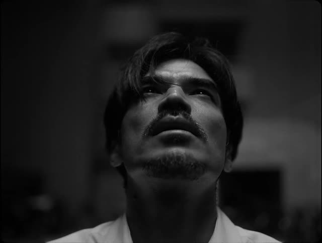 Black and white shot of a man looking up
