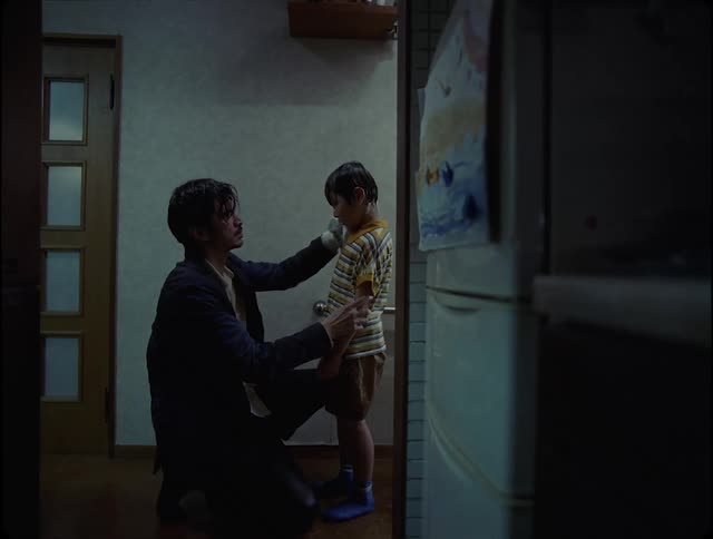 Father dries his son with a towel in the bathroom