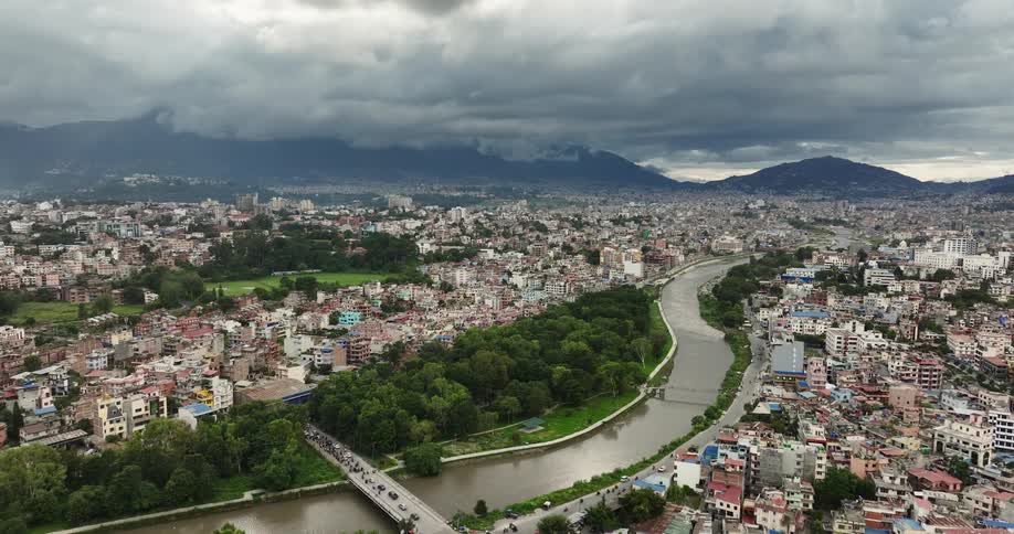 Aerial view of a river running through a city on a cloudy day