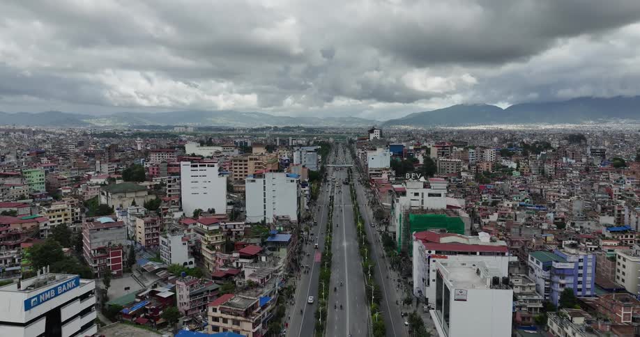 Aerial panorama of a thirdworld city with a central highway and buildings and slums in the vicinity