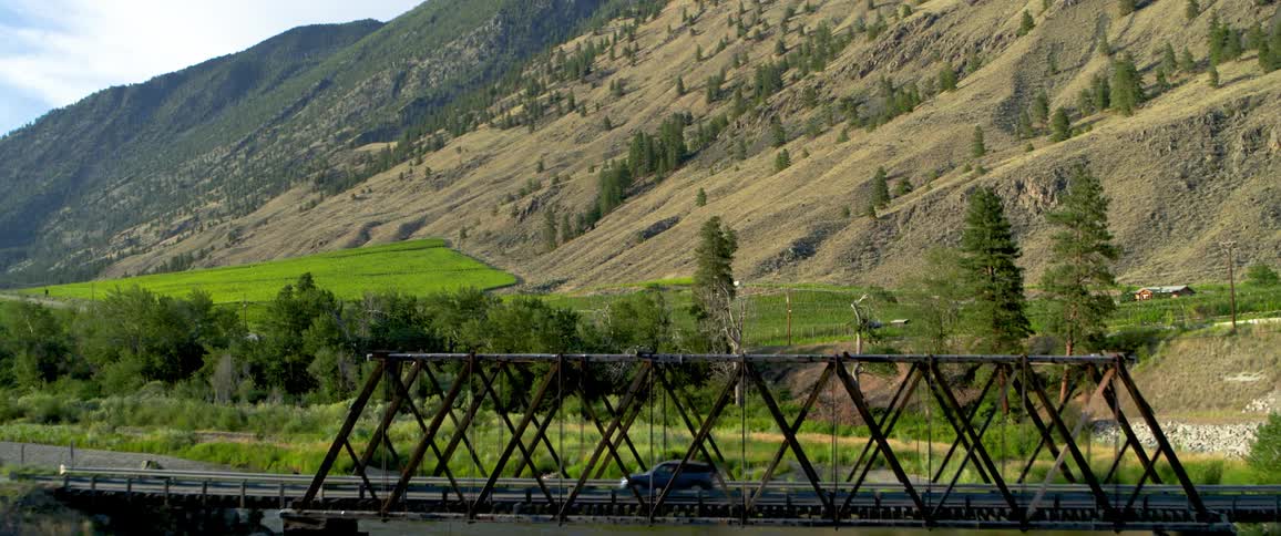 Cars moving by a bridge leading to a highway